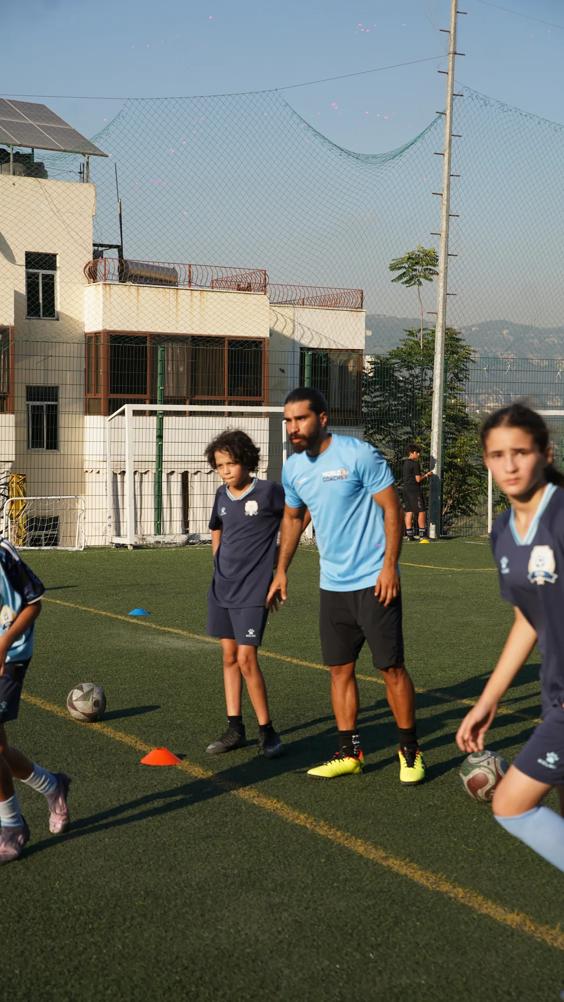 Coach leading a drill with young players