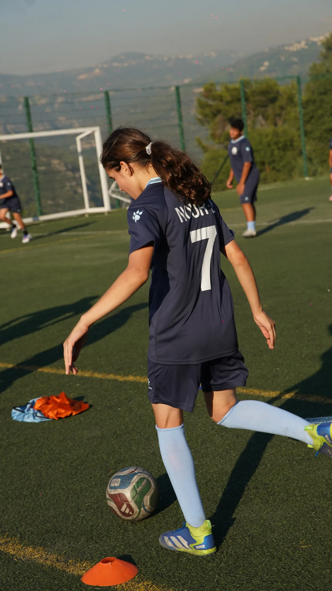 Player dribbling through cones